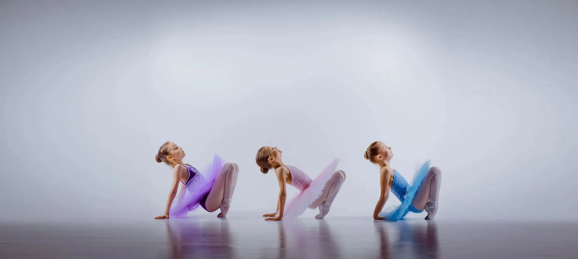 Three little girls dancing together